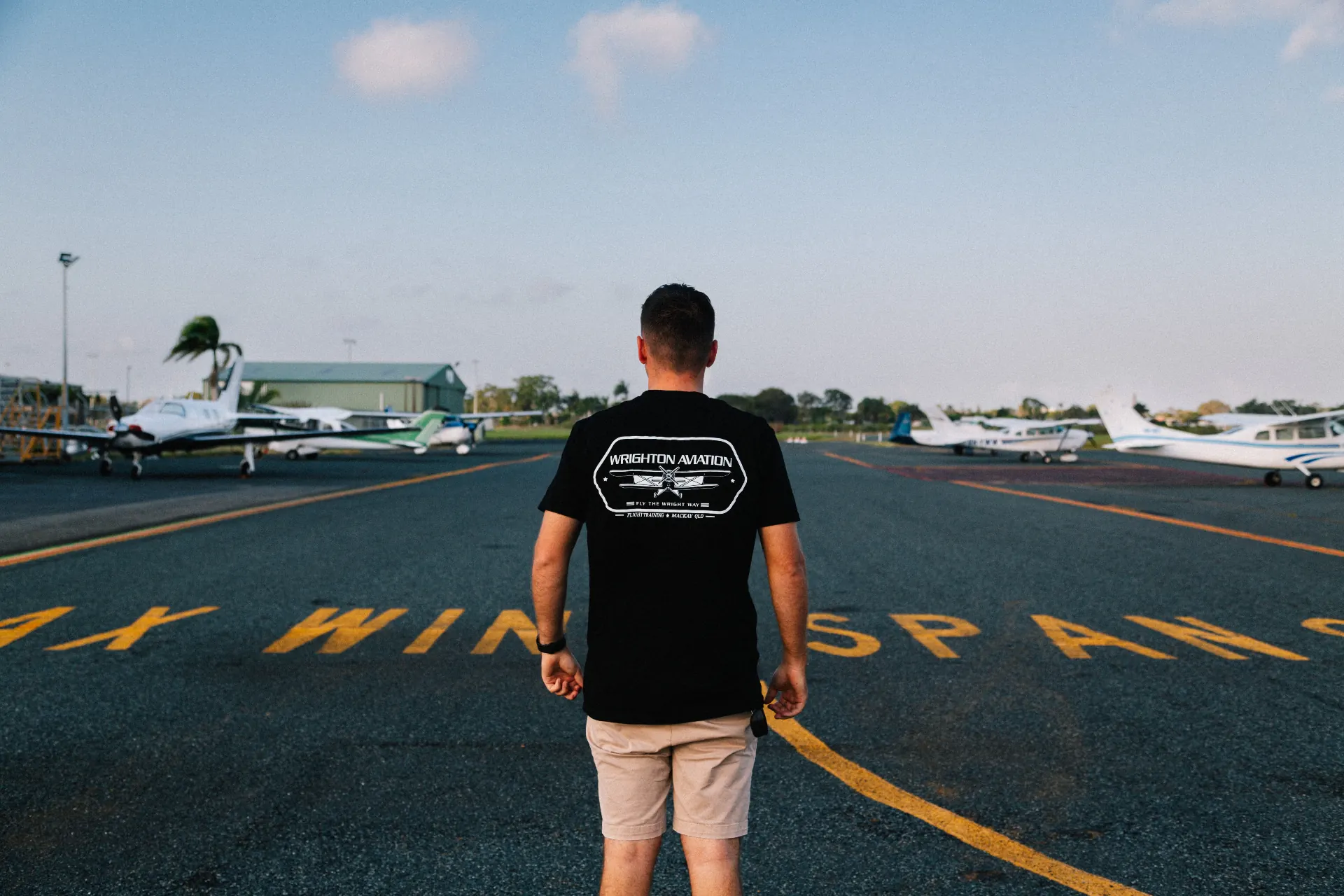 Wrighton Aviation pilot standing on the runway with training aircraft